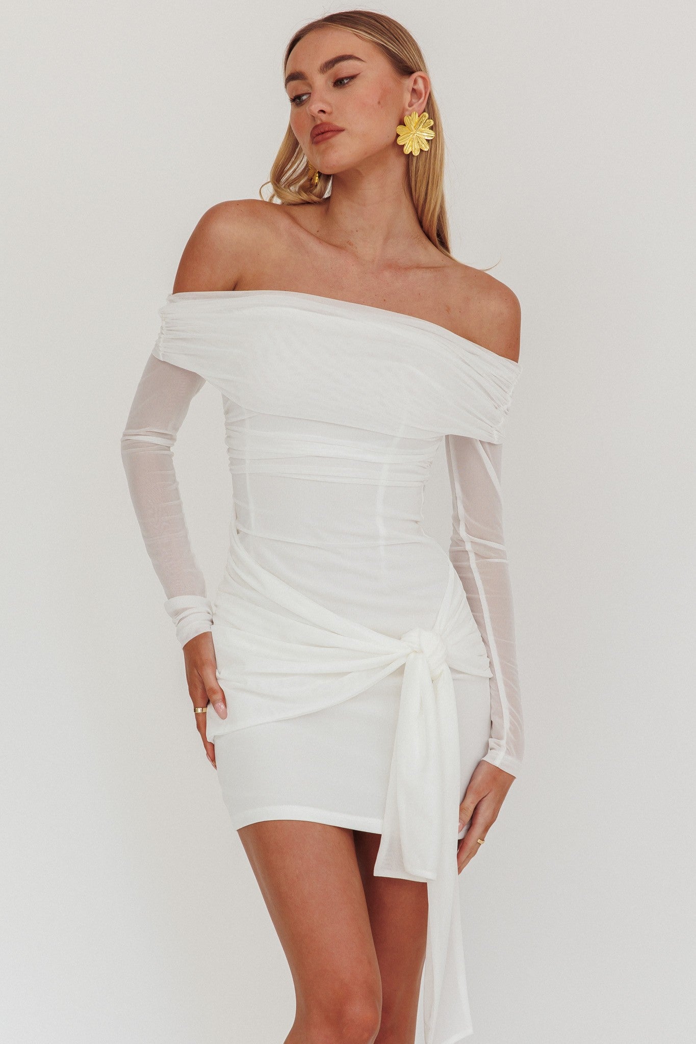 Celestial Dream Off Shoulder Mesh Mini Dress in white, featuring long sleeves and a front wrap tie.
