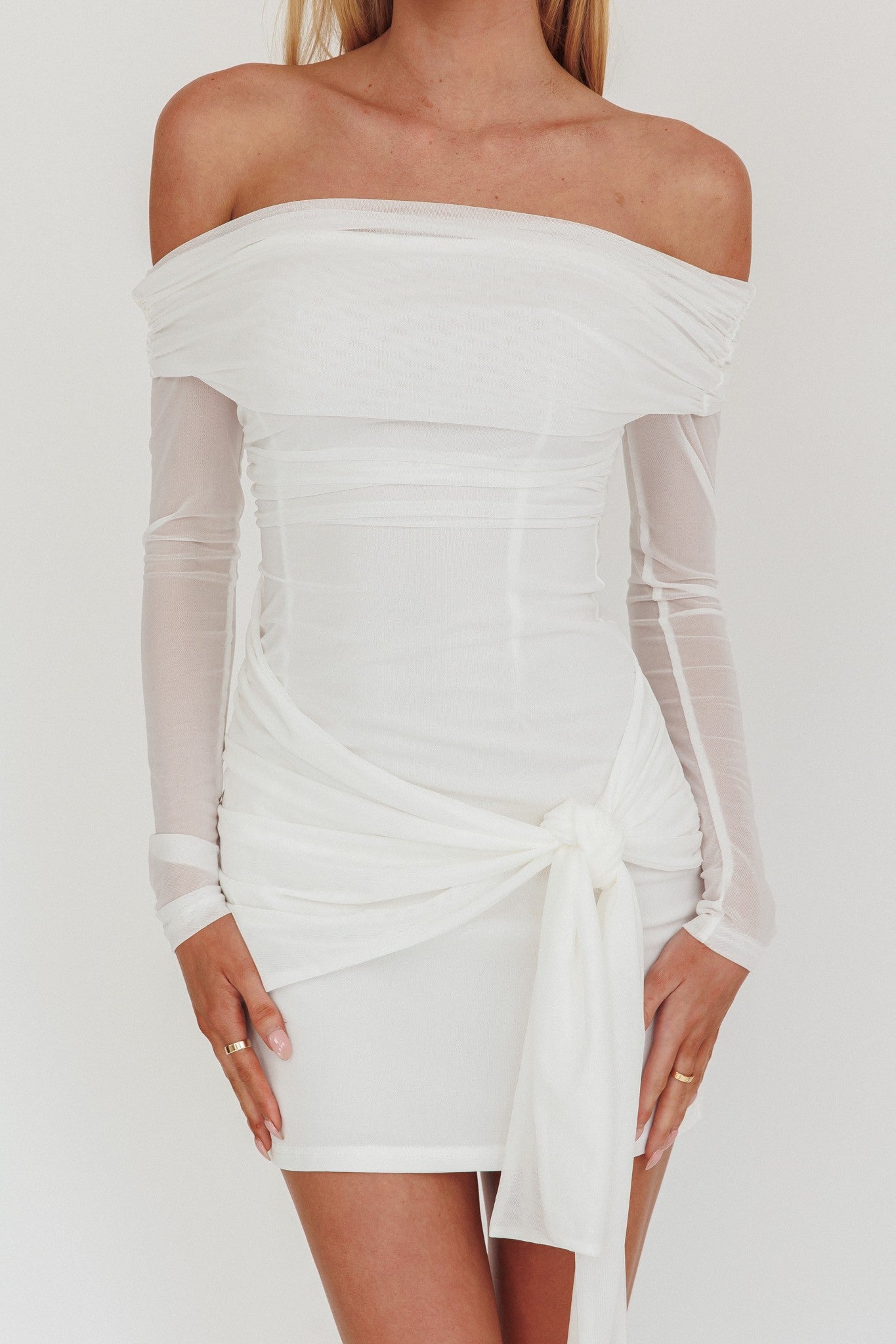 Celestial Dream Off Shoulder Mesh Mini Dress in white, featuring long sleeves and a front wrap tie.