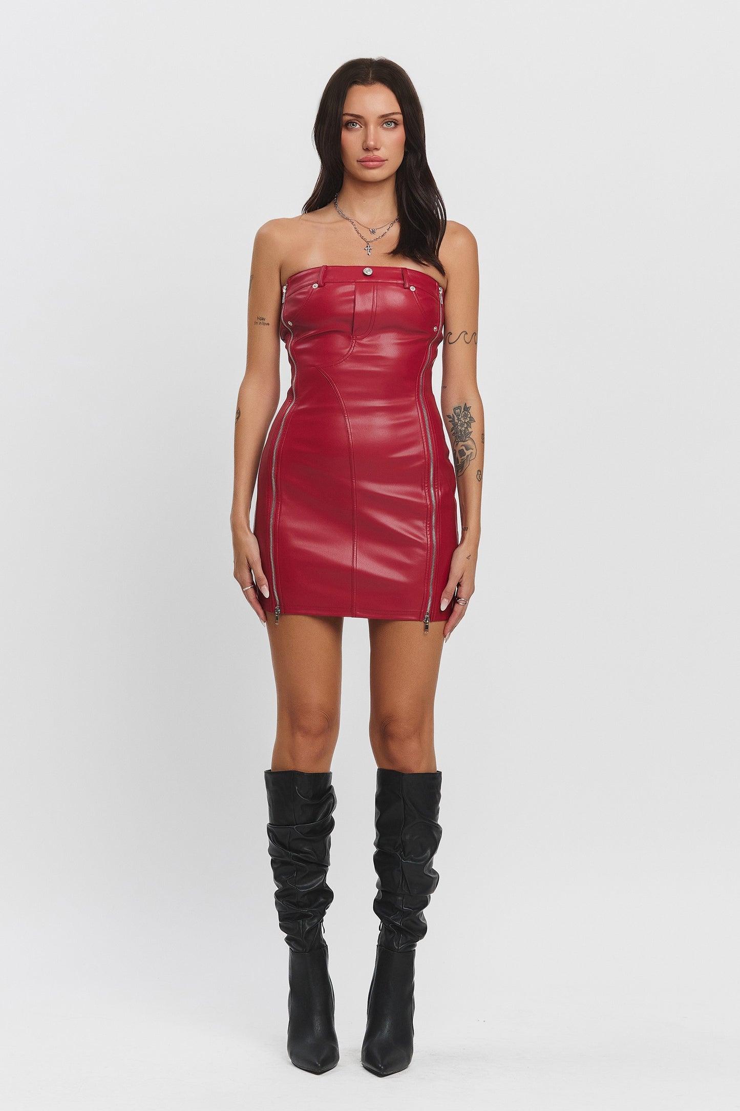 Rogue Temptation Mini Dress featuring a faux leather tube top design with side zipper details, belt loops, and bodycon fit in red.