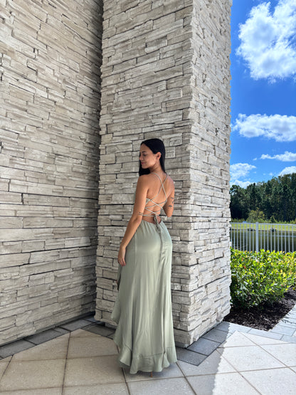 Sage satin maxi dress with a corset bodice, ruffled surplice skirt, and open back tie details, perfect for formal spring occasions