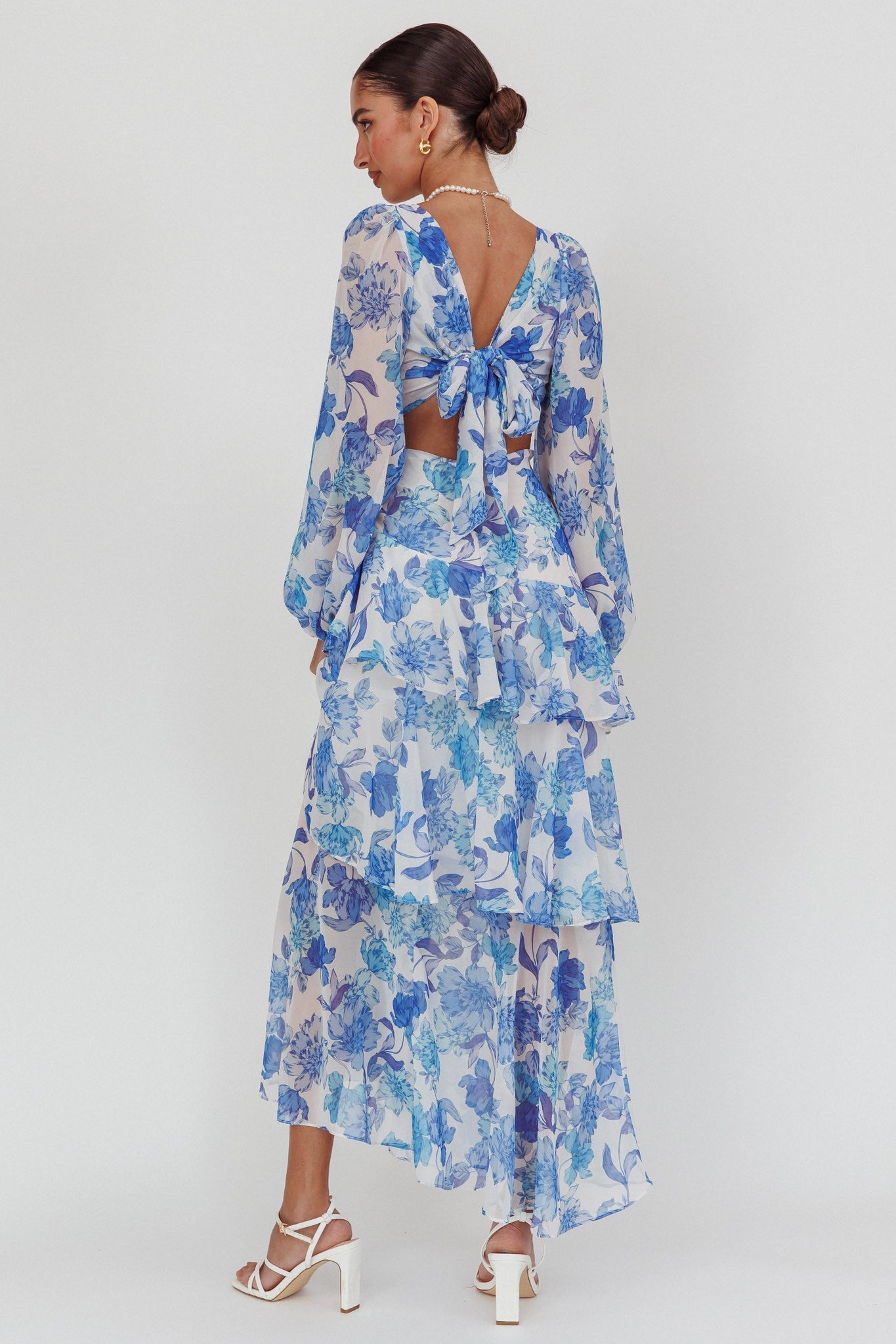 Long sleeve blue floral tiered maxi dress with deep V neckline and back tie wrap.