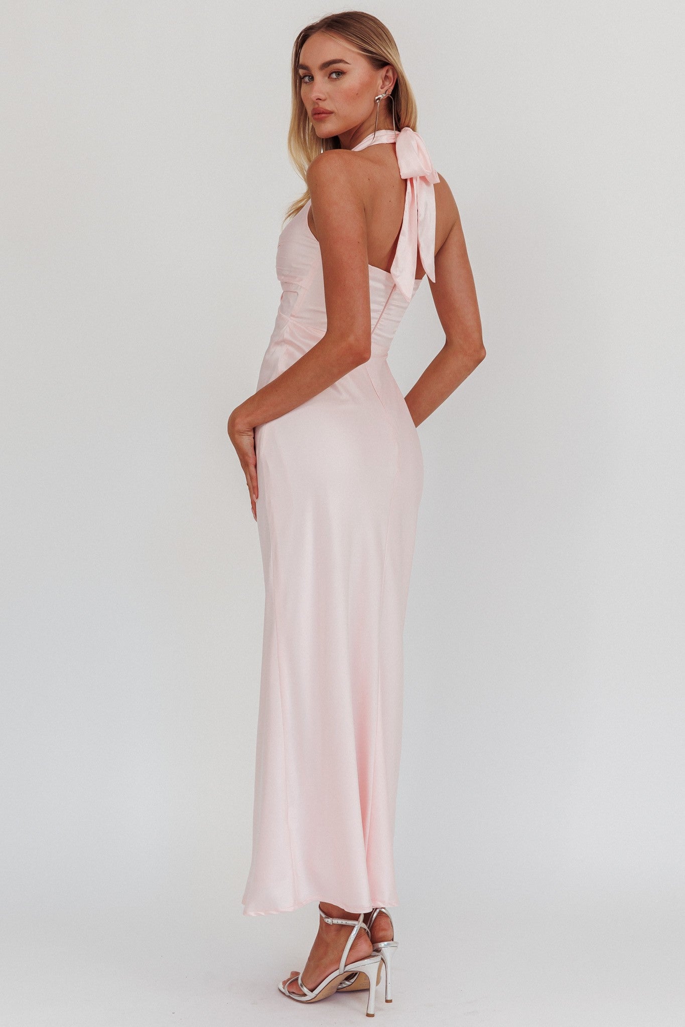 Halter neck front twist maxi dress in pink with open back and bow tie.