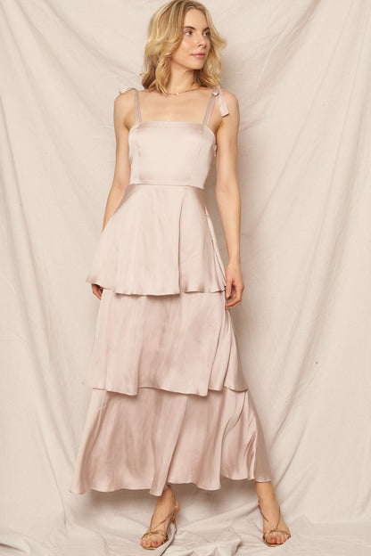 Shoulder-tie satin tiered maxi dress in champagne color, perfect for feminine holiday looks and special occasions.