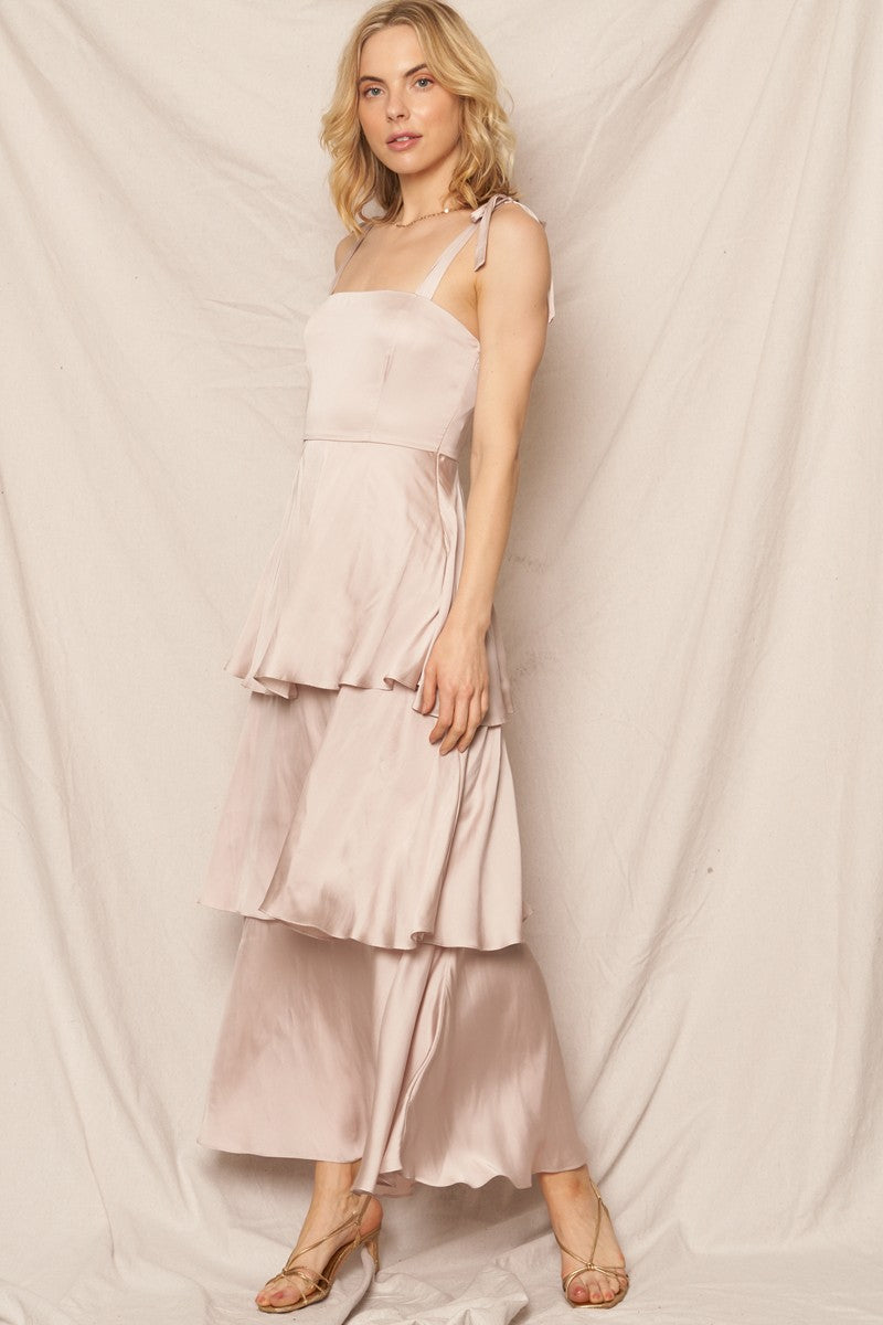 Shoulder-tie satin tiered maxi dress in champagne color, perfect for feminine holiday looks and special occasions.