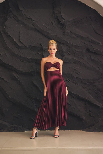 Burgundy strapless dress featuring a twist-front bodice and flowy pleated skirt, perfect for formal events and elegant celebrations.