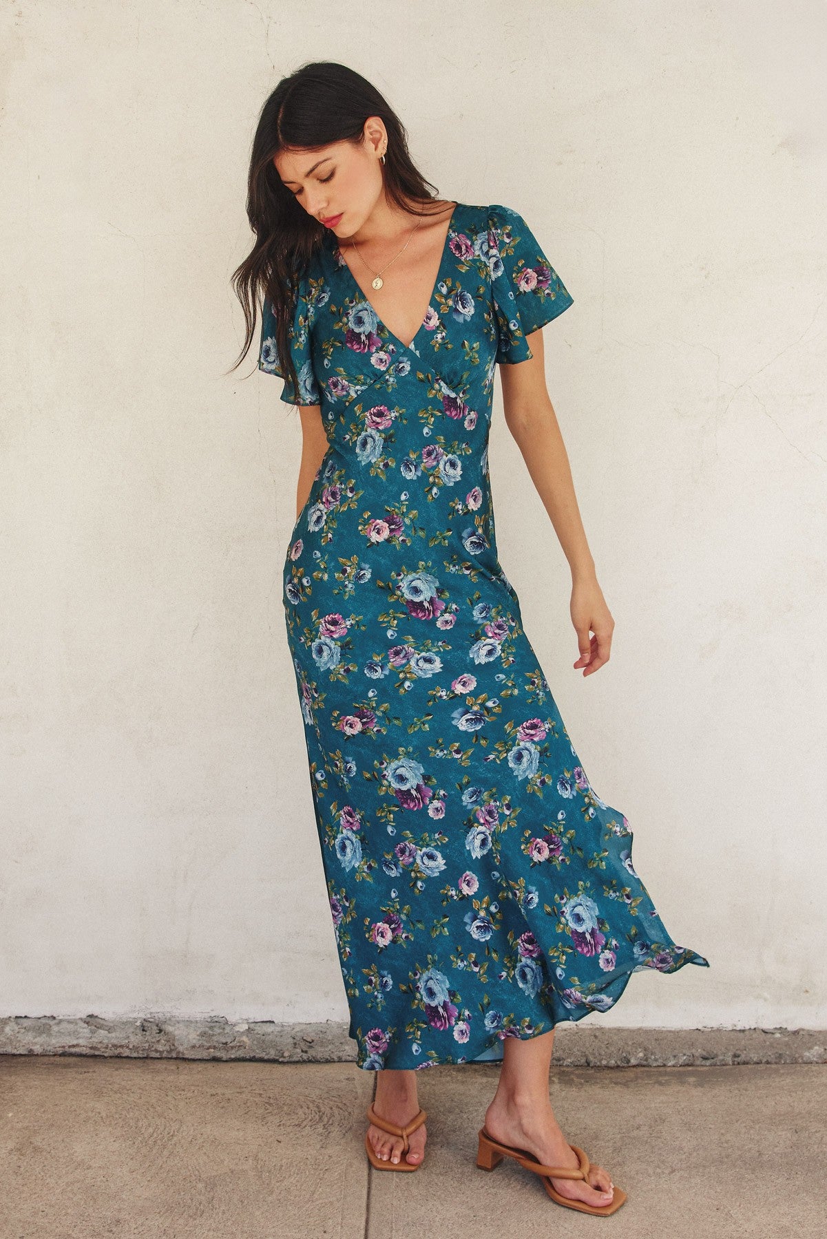 Forest green floral maxi dress with flutter sleeves, plunging neckline, and side slit.