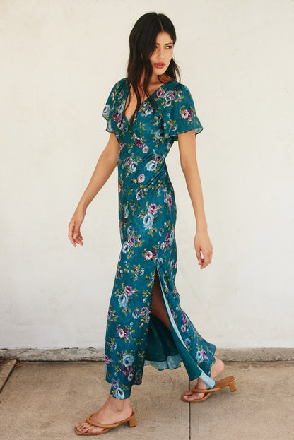 Forest green floral maxi dress with flutter sleeves, plunging neckline, and side slit.