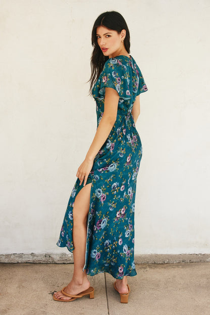 Forest green floral maxi dress with flutter sleeves, plunging neckline, and side slit.