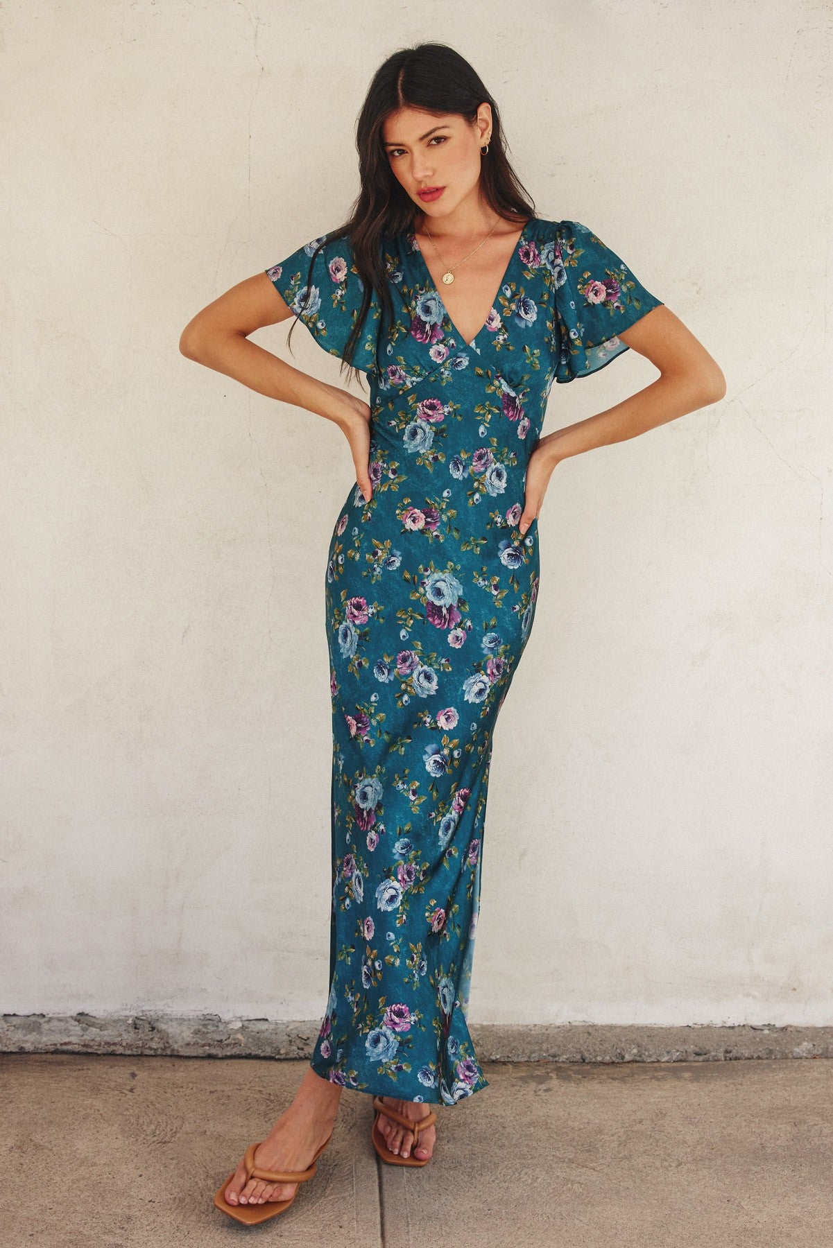 Forest green floral maxi dress with flutter sleeves, plunging neckline, and side slit.