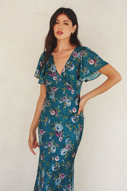 Forest green floral maxi dress with flutter sleeves, plunging neckline, and side slit.