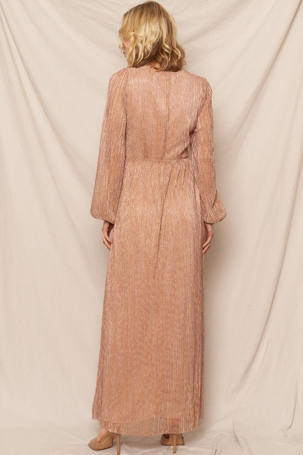 Blush gold shimmer maxi dress with a V-neckline and tie-back detail, perfect for festive and glamorous events.