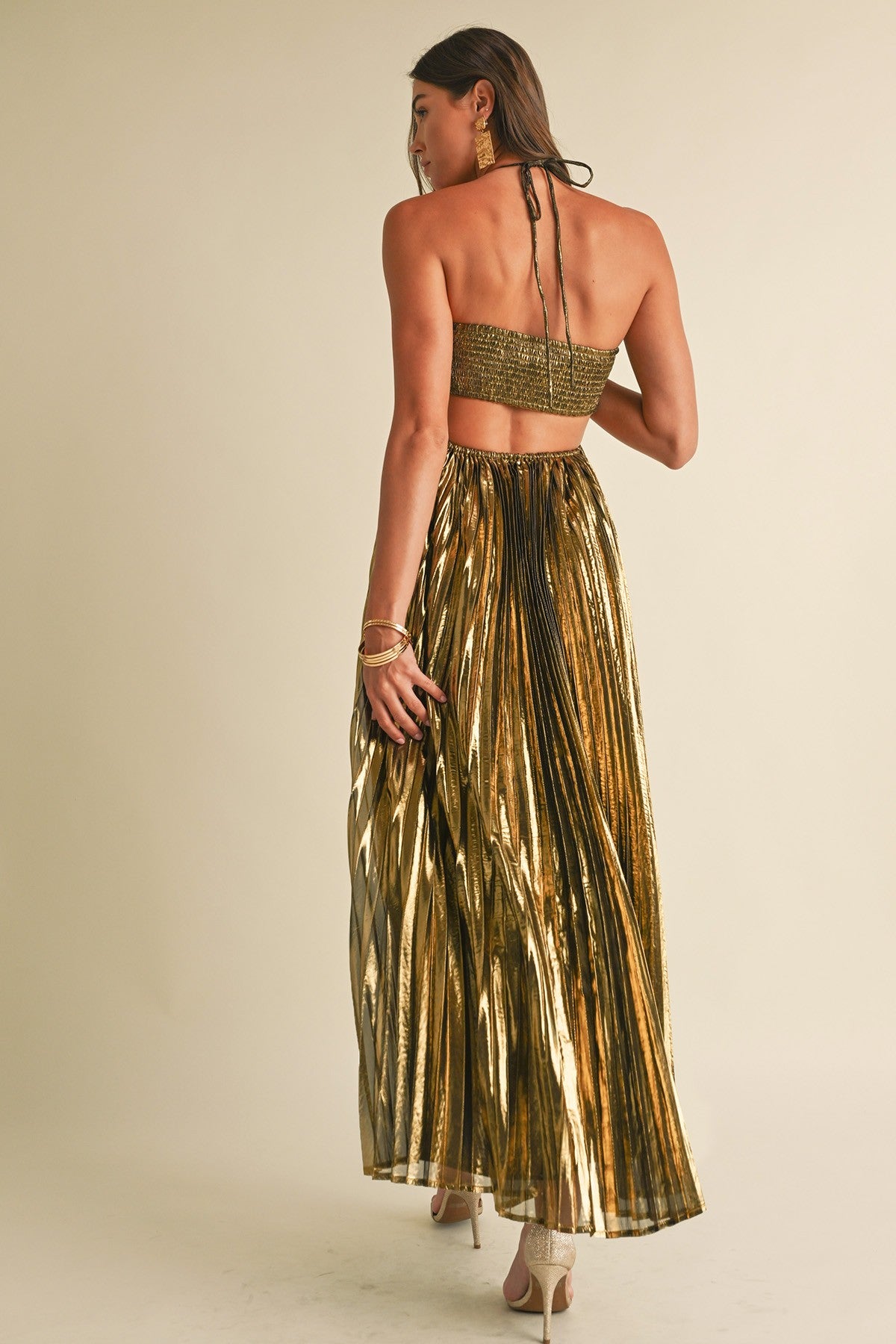 Golden Gleam Pleated Maxi Dress with all-over pleating, a halter neckline, and a luxurious metallic finish, in gold.