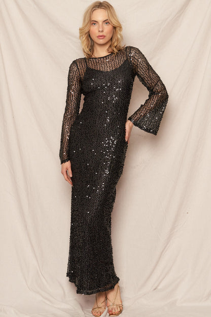 Black sequin maxi dress with elegant bell sleeves, perfect for New Year's celebrations and glamorous events.