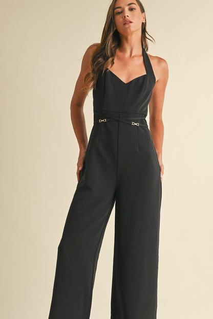 Noir Luxe Halter Jumpsuit in black with a wide-leg fit, gold trim detail, and a back zipper closure.