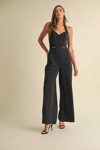 Noir Luxe Halter Jumpsuit in black with a wide-leg fit, gold trim detail, and a back zipper closure.