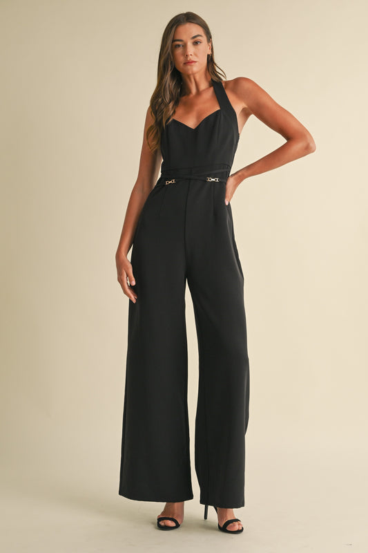 Noir Luxe Halter Jumpsuit in black with a wide-leg fit, gold trim detail, and a back zipper closure.