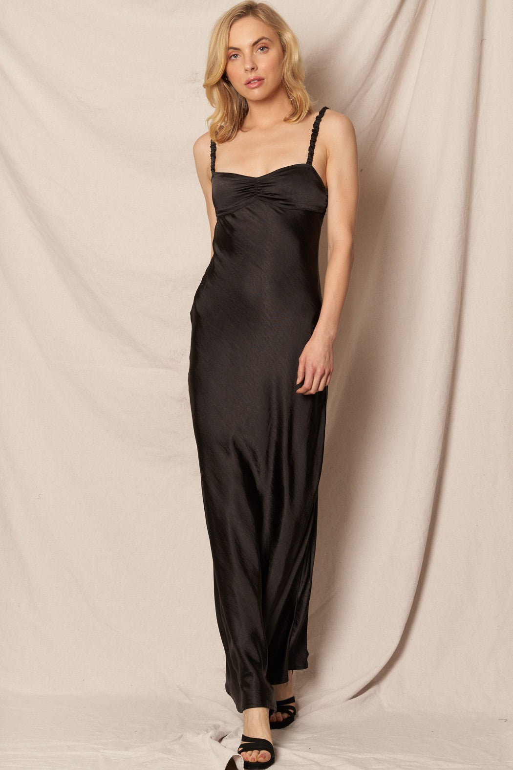 Black satin maxi dress with a sweetheart neckline, perfect for formal New Year’s Eve and holiday celebrations.