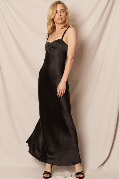 Black satin maxi dress with a sweetheart neckline, perfect for formal New Year’s Eve and holiday celebrations.