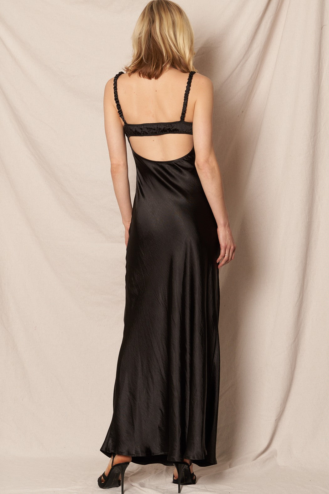 Black satin maxi dress with a sweetheart neckline, perfect for formal New Year’s Eve and holiday celebrations.