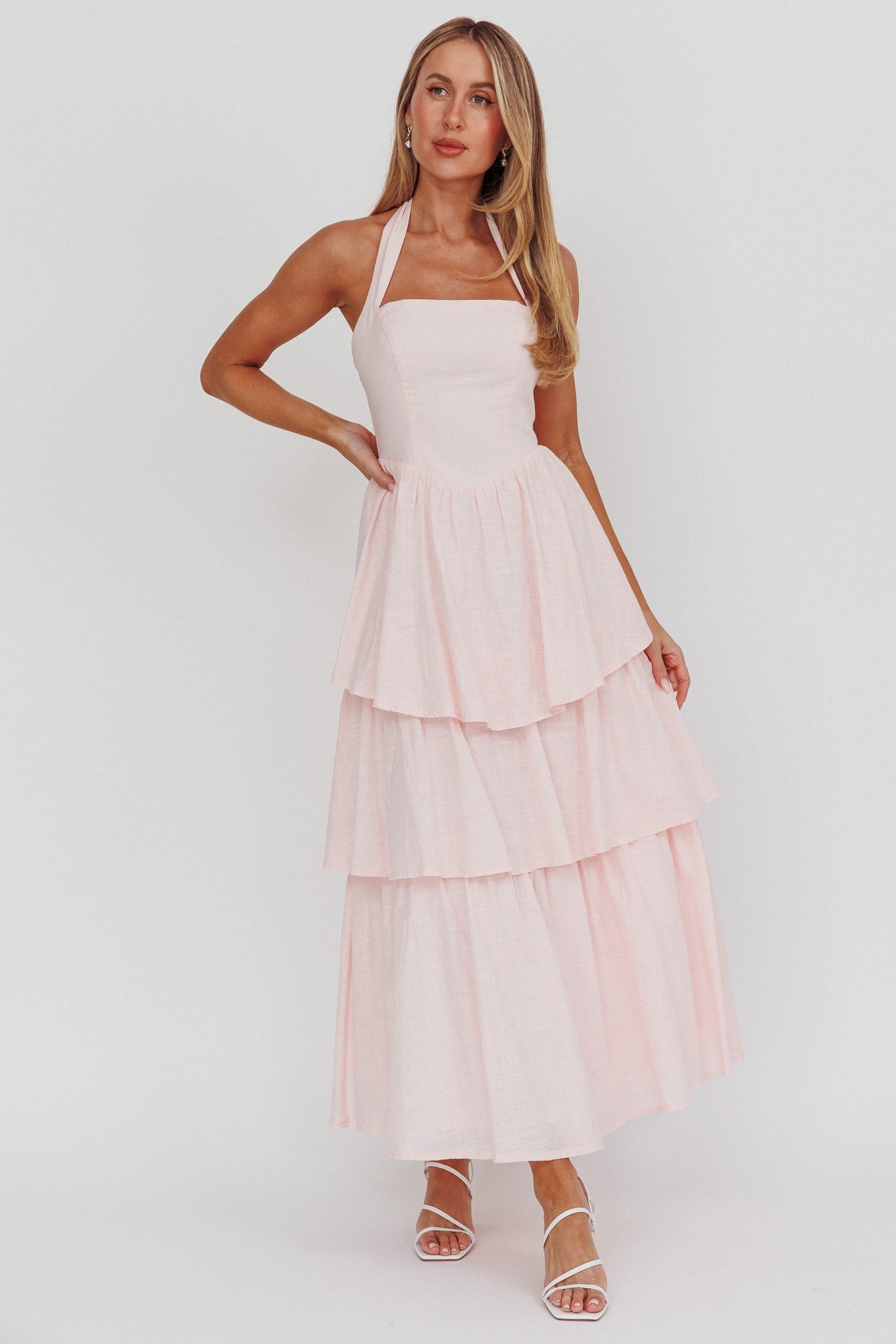 Pink Whisper Halter neck Corset Dress in pastel pink with a tiered skirt, halter top, and back zipper.