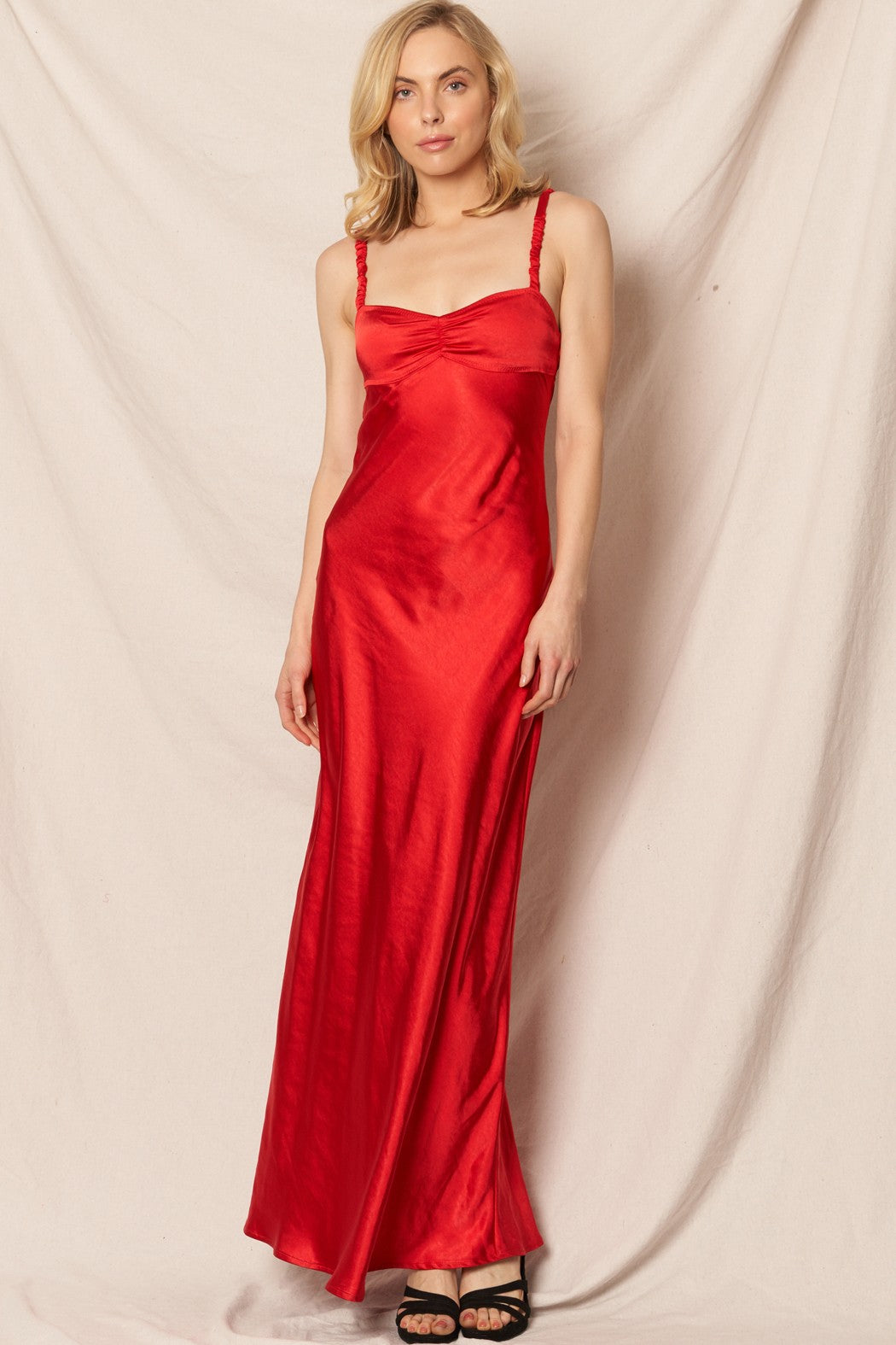 Red satin sleeveless maxi dress with a sweetheart neckline, perfect for New Year’s Eve and holiday events.