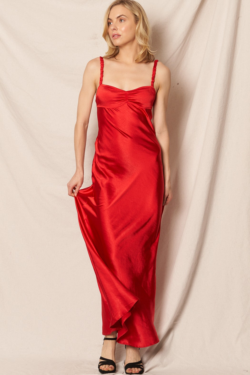 Red satin sleeveless maxi dress with a sweetheart neckline, perfect for New Year’s Eve and holiday events.