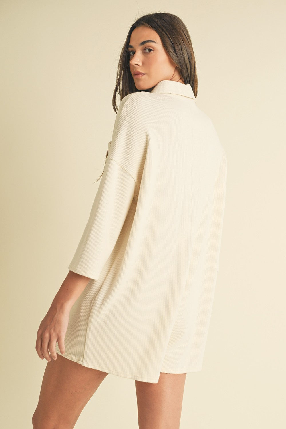  Soft Cream Knit Romper with long sleeves, button placket, and classic neckline. Ideal for casual daywear.