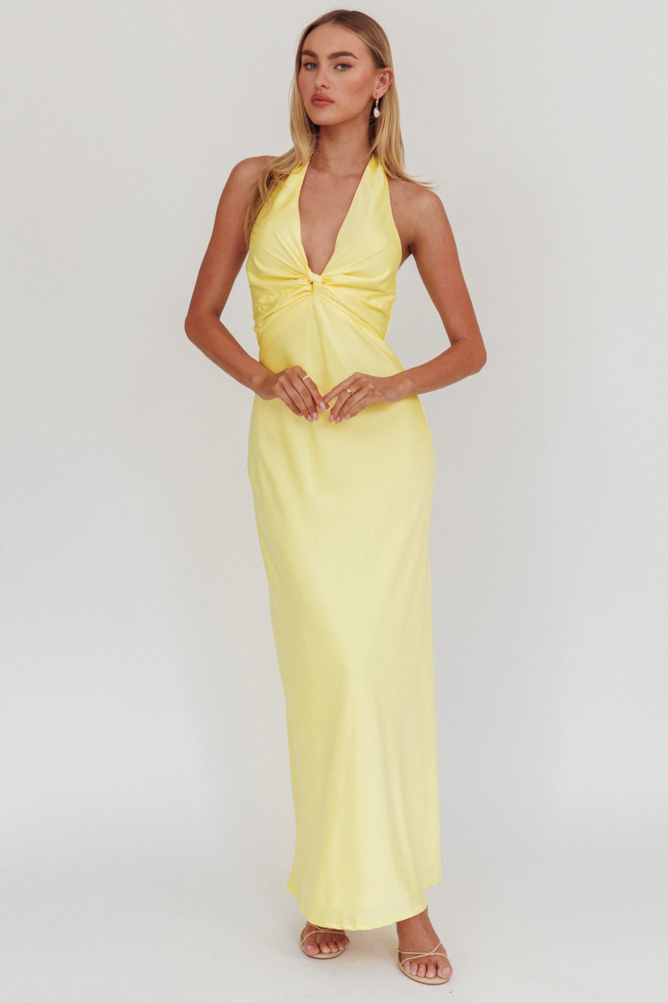 Halter neck front twist maxi dress in lemon with open back and bow tie.