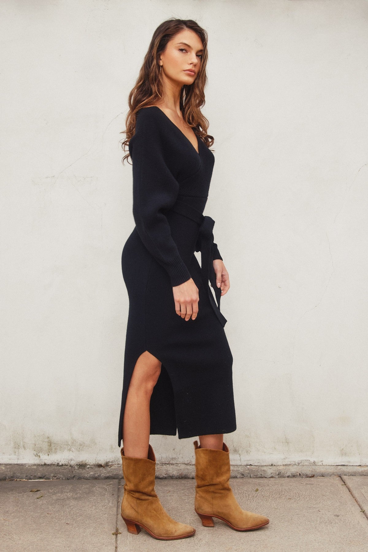 Elegant black knit midi dress with a wide surplice neckline, dolman long sleeves, and a sash belt, perfect for casual outings or Valentine's Day.