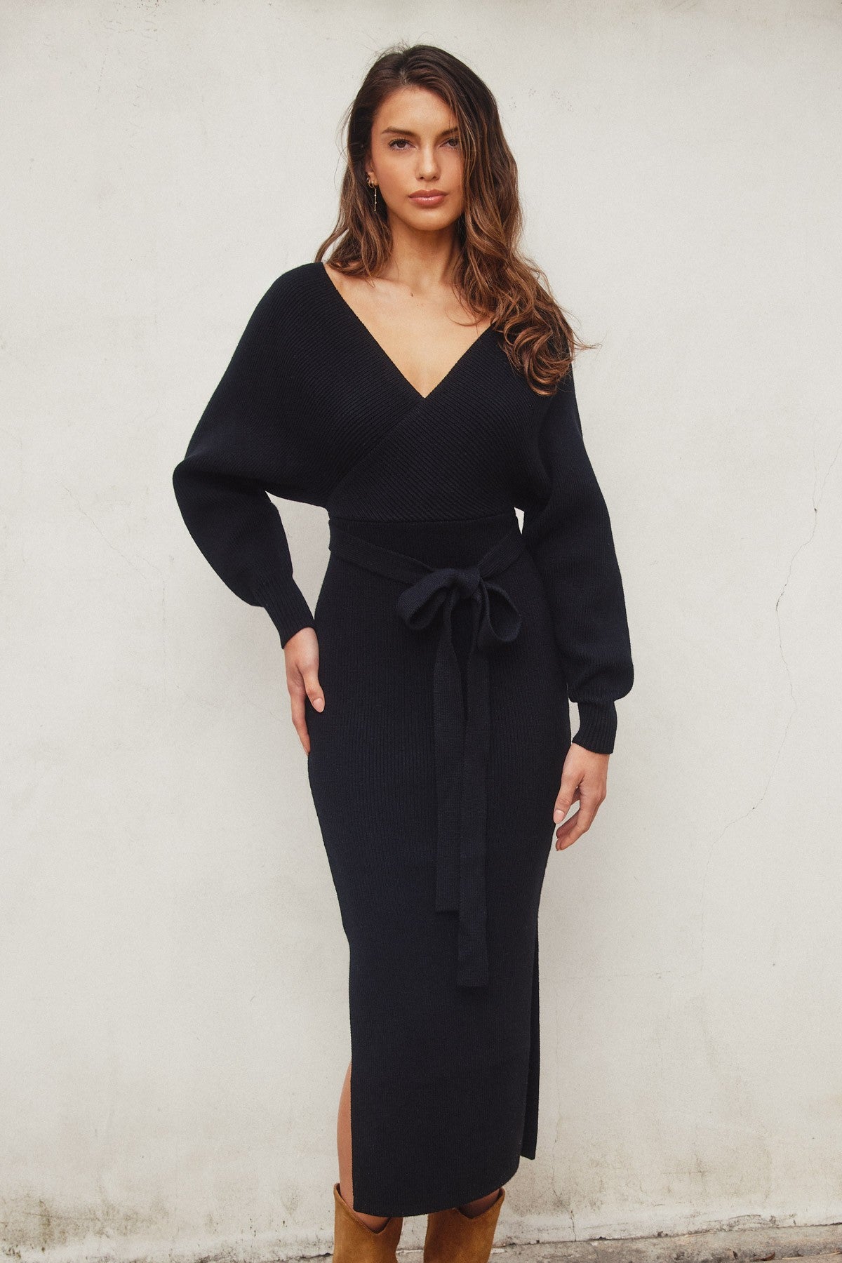 Elegant black knit midi dress with a wide surplice neckline, dolman long sleeves, and a sash belt, perfect for casual outings or Valentine's Day.