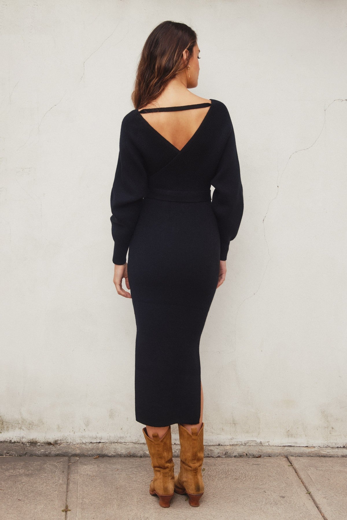 Elegant black knit midi dress with a wide surplice neckline, dolman long sleeves, and a sash belt, perfect for casual outings or Valentine's Day.