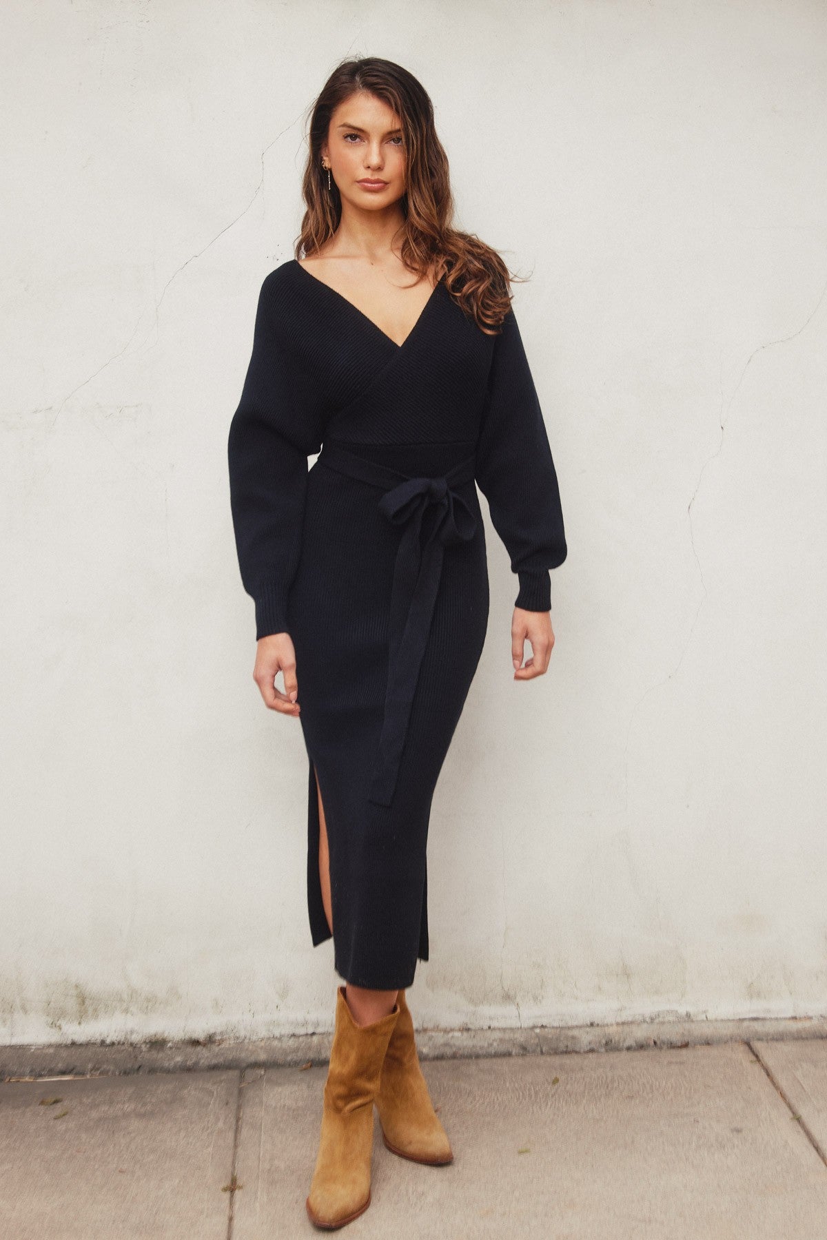 Elegant black knit midi dress with a wide surplice neckline, dolman long sleeves, and a sash belt, perfect for casual outings or Valentine's Day.