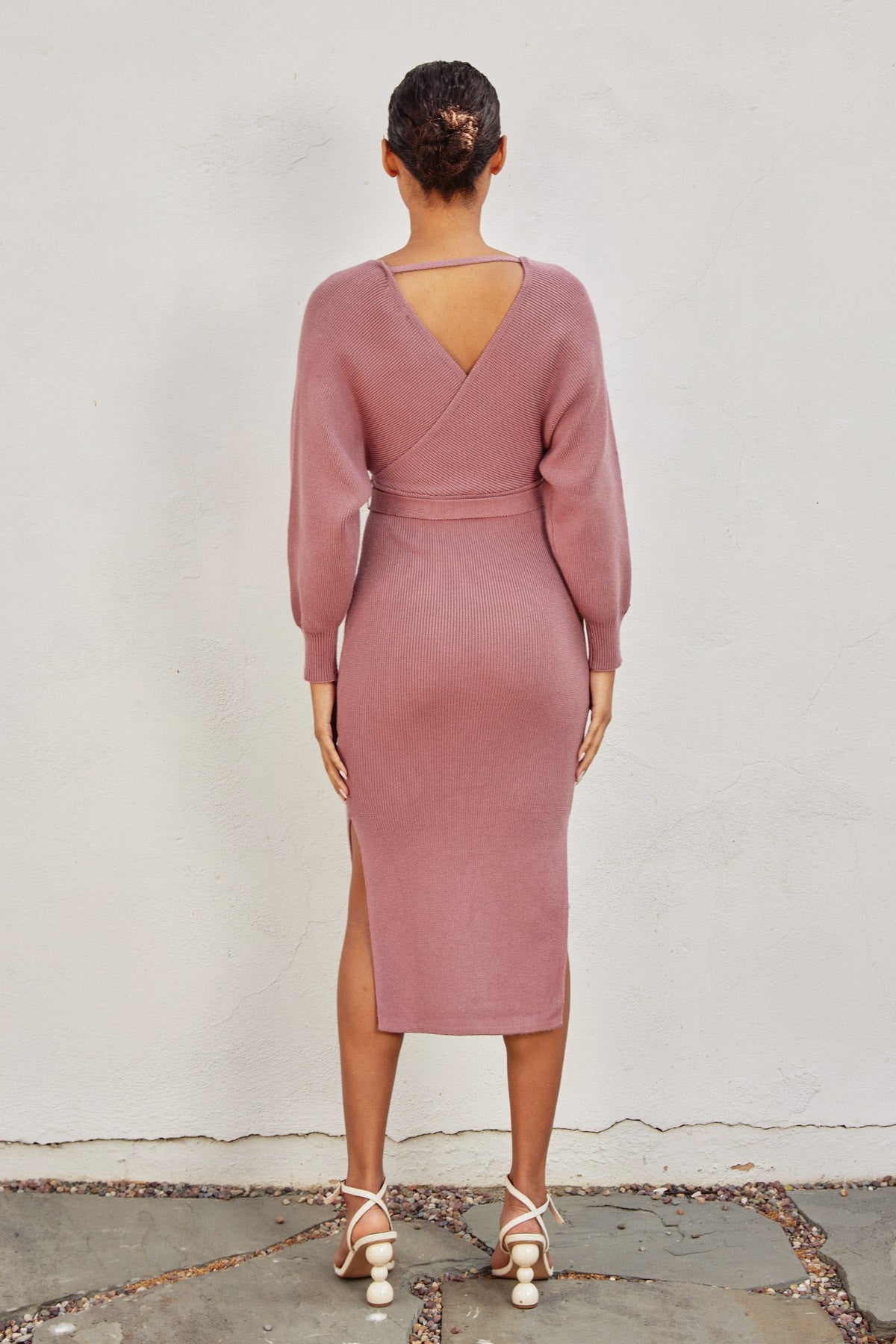 Elegant pink knit midi dress with a wide surplice neckline, dolman long sleeves, and a sash belt, perfect for casual outings or Valentine's Day.