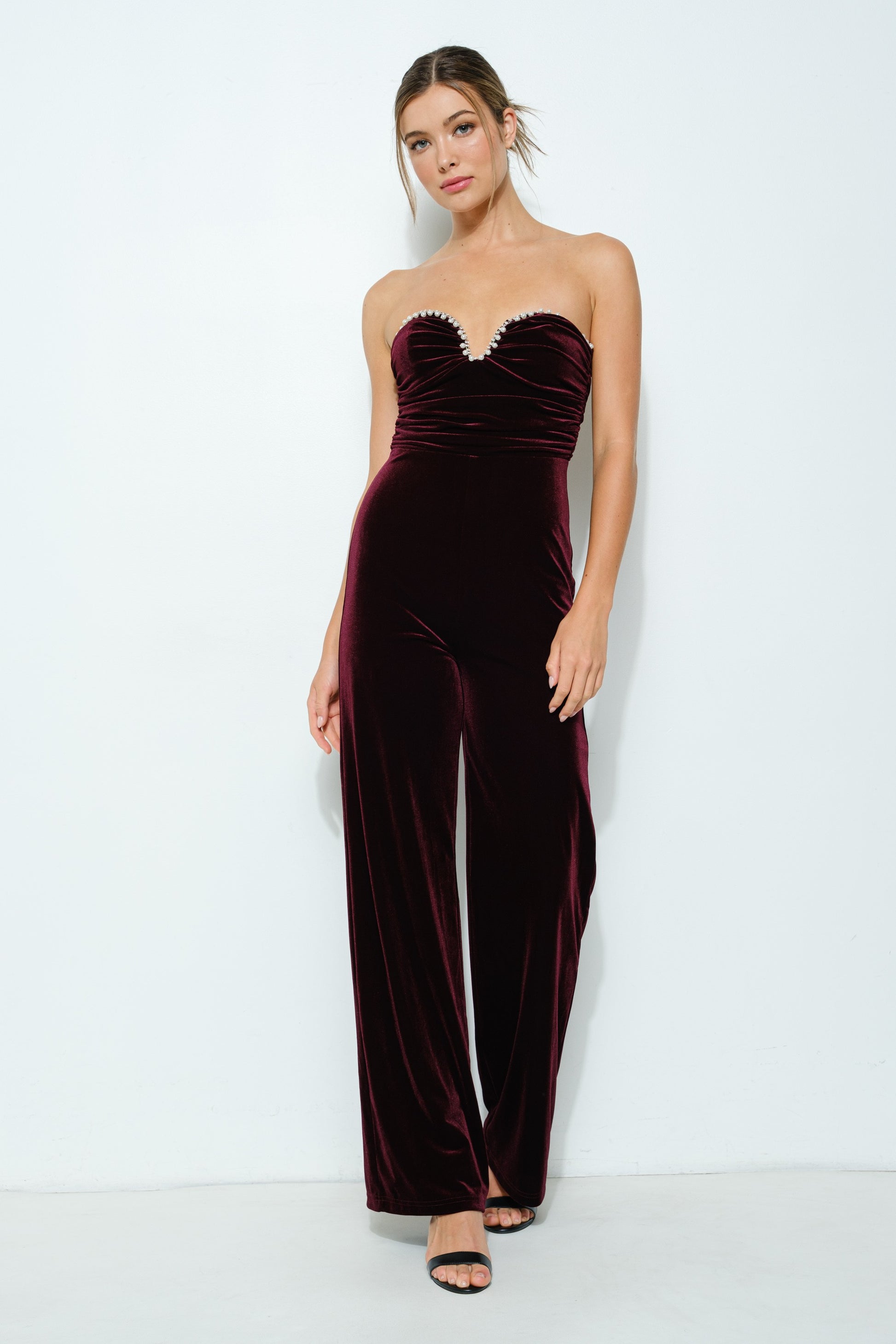 Velvet Elegance Pearl-Trim Jumpsuit in wine color, featuring a strapless sweetheart neckline, faux pearl trim, and wide-leg pants.