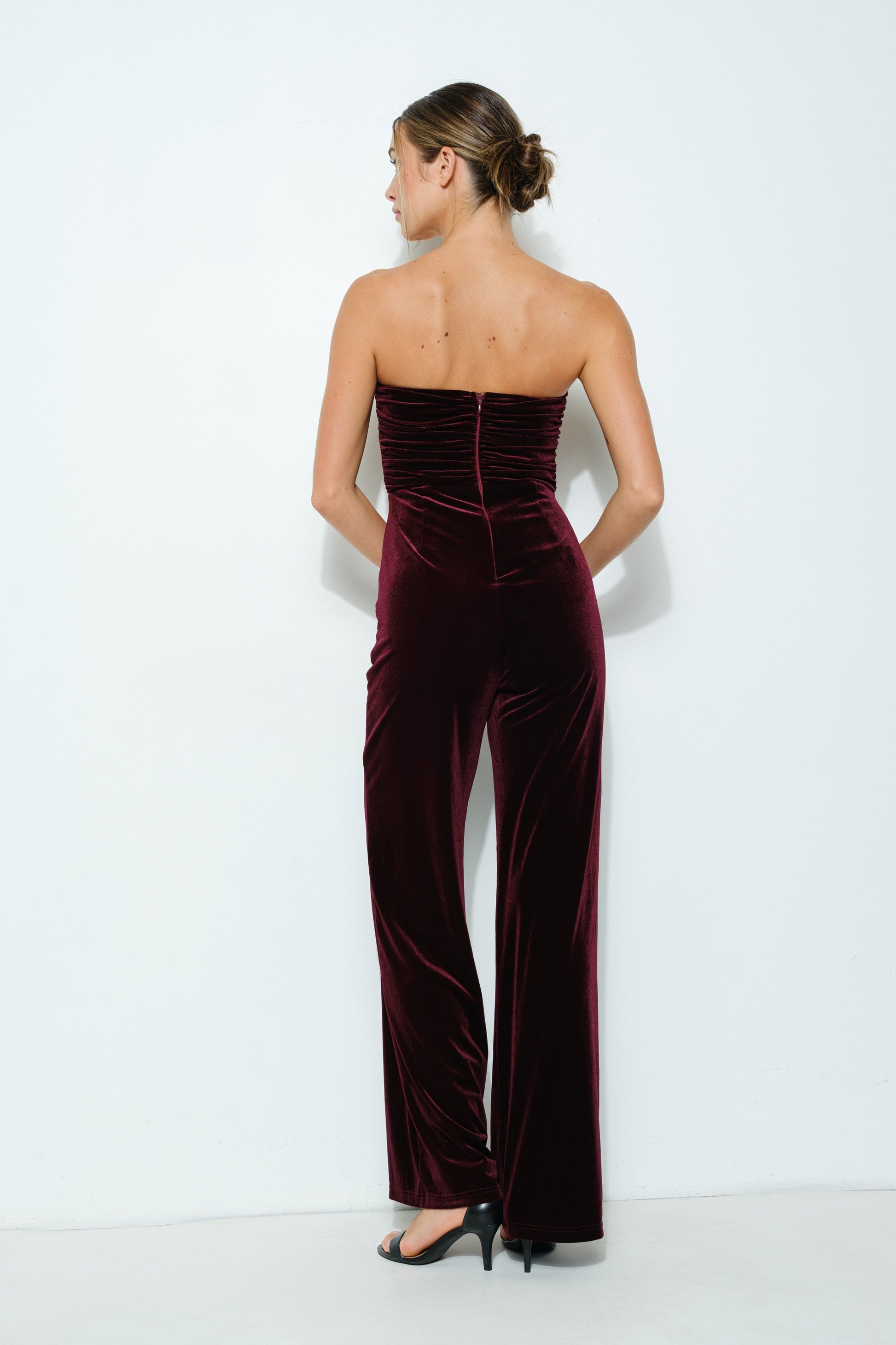 Velvet Elegance Pearl-Trim Jumpsuit in wine color, featuring a strapless sweetheart neckline, faux pearl trim, and wide-leg pants.