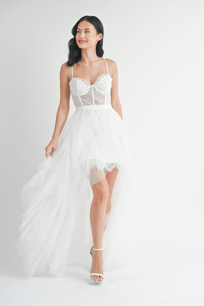 White strapless tulle maxi dress with a structured lace bodice, side slit, and ruffled mesh outer layer.